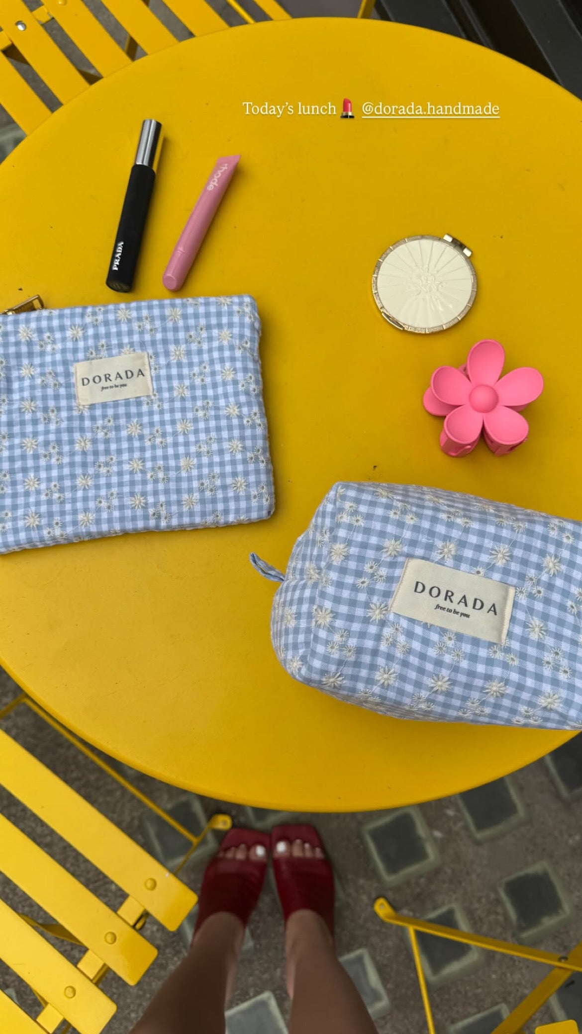 Two checkered pouches with 'DORADA' branding on a yellow surface.